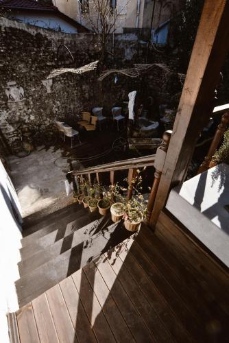 a group of potted plants on a wooden stairs at Atelier Boutique Hotel in Shkodër