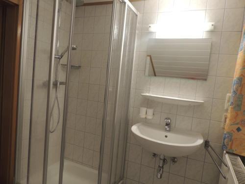 a bathroom with a shower and a sink at Villa Anna in Bad Gastein