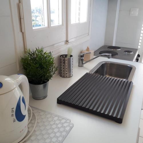 a kitchen sink with a draining mat next to it at Asprokavos beach apartment and studio in Kavos