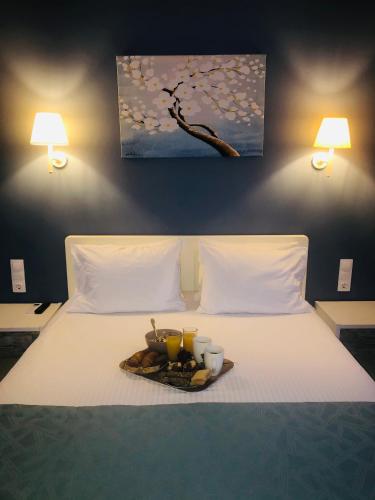 a tray of food on a bed with two lamps at Villa Marietta in Sidari