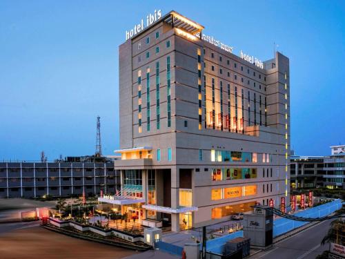 a tall building with lights on top of it at ibis Bengaluru Hosur Road - An Accor Brand in Bengaluru