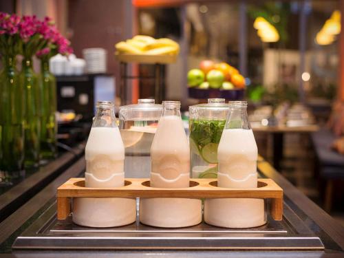 three bottles of milk sitting on a counter at Novotel São Paulo Berrini in Sao Paulo