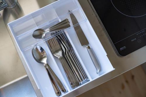 a white tray with silver utensils on a counter at Tamatsukuri Daifuji Kan in Osaka
