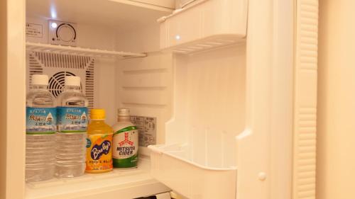 a refrigerator filled with lots of bottles of water at Spa Hotel Alpina Hida Takayama in Takayama