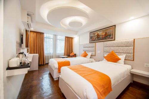 Postel nebo postele na pokoji v ubytování Durbar Hotel & Residence