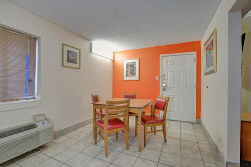 a dining room with a wooden table and chairs at Americas Best Value Inn Laredo in Laredo