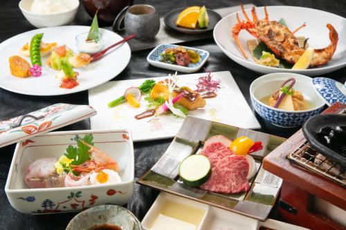 una mesa con platos de comida. en Yufuin Hoteiya, en Yufu