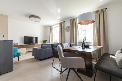a living room with a table and a living room with a couch at Uiferhäuser in Illmitz