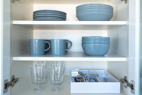 a cupboard filled with blue bowls and plates at Tamatsukuri Daifuji Kan in Osaka