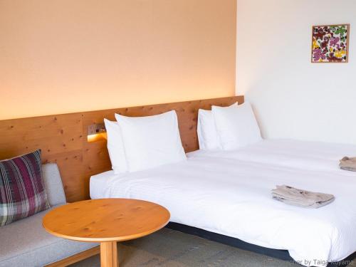 Un ou plusieurs lits dans un hébergement de l'établissement HOTEL STRATA NAHA