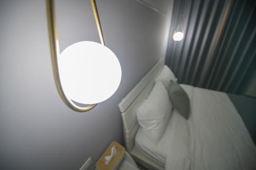 a bathroom with a toilet and a light on a plane at 漫時光 旅空間 ManLu INN in Jinning