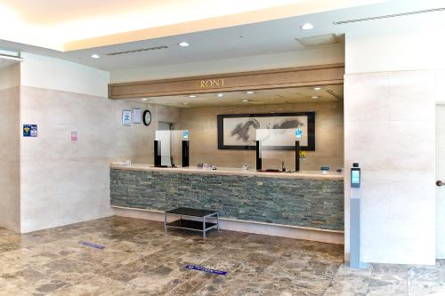 a lobby of a hotel with a waiting area at Hotel Crown Hills Toyohashi in Toyohashi
