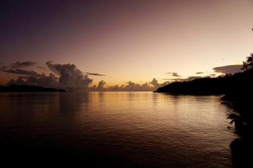 a sunset over a body of water at Coin D'or in Anse Possession