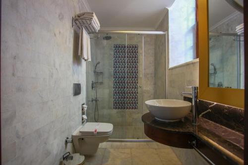a bathroom with a sink and a toilet and a shower at Alp Pasa Hotel - Special Class in Antalya