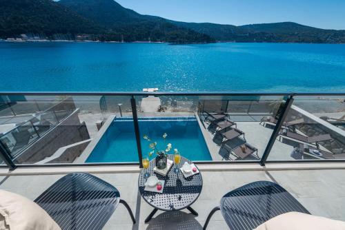 a balcony with a swimming pool and a view of a lake at Ville Sol Del Mar in Slano