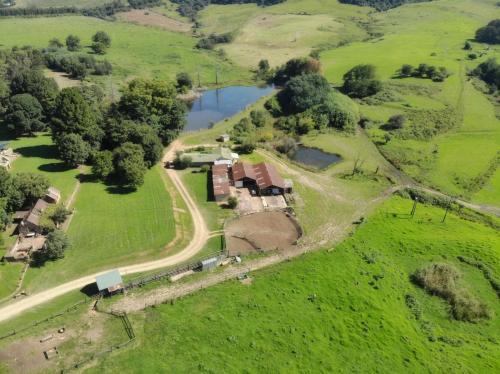 an aerial view of an old farm with a river at Old Balgowan Farm Cottage in Balgowan