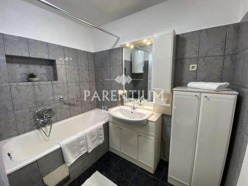 a bathroom with a tub and a sink and a bath tub at Apartment Ronaldo in Poreč