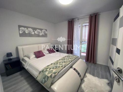 a bedroom with a large bed in a room at Apartment Ronaldo in Poreč