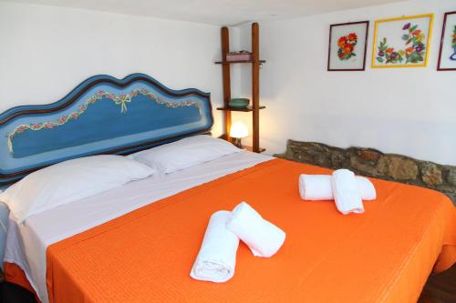 a bed with two rolled towels on top of it at Casa Saraceni (by Vacation Service) in Cefalù