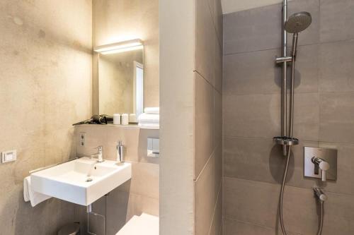 a bathroom with a sink and a shower at Mettnau-apartment in Radolfzell am Bodensee