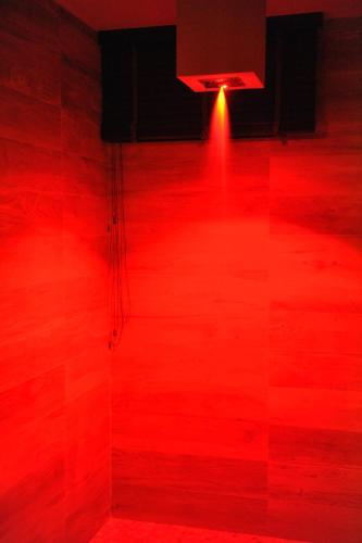 a red floor with a red light in a room at Hotel Casali in Cesena
