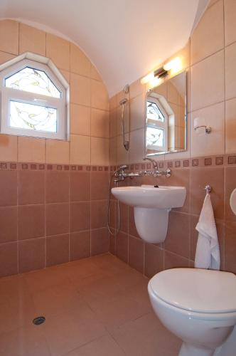 a bathroom with a toilet and a sink at Guest House Hiora in Ahtopol