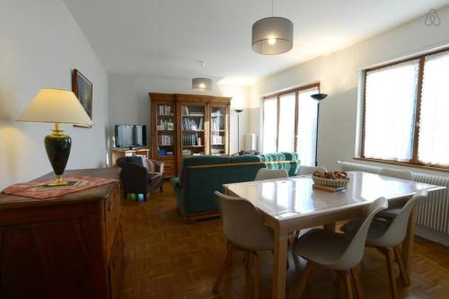 a living room with a table and chairs and a couch at Le Verger - Maison de vacances Route des Vins in Hunawihr