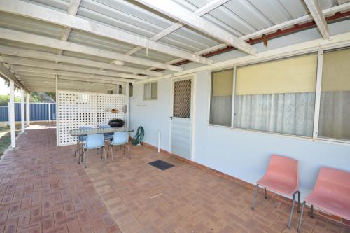 a covered patio with a table and chairs at Red Rock Retreat C - Kalbarri WA in Kalbarri