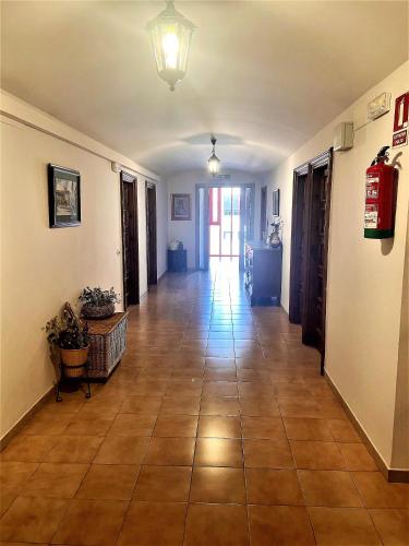 a hallway with a tile floor in a house at MONASTERIO de SANTA MARÍA DE VALVANERA in Anguiano