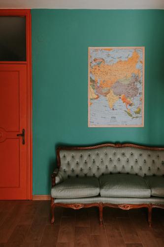 a couch in a room with a map on the wall at Habari We Dorm in Bari
