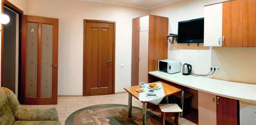 a small kitchen with a table in a room at Котедж-парк Славна in Okhtyrka