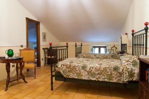 a bedroom with a bed and a table at Torre Camigliati Dimora Storica in Camigliatello Silano