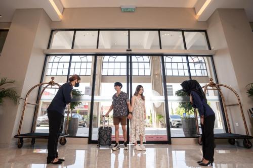 a group of people standing in front of a lobby at D ELEGANCE GRAND BANDAR SERI ALAM in Masai
