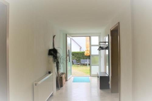 a hallway with a door leading to a patio at Ferienwohnung Morgentau in Germersheim