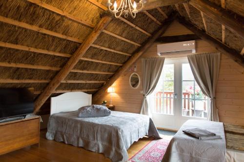 a bedroom with a bed and a large window at Avar puhkekompleks saunaga in Kuusiku