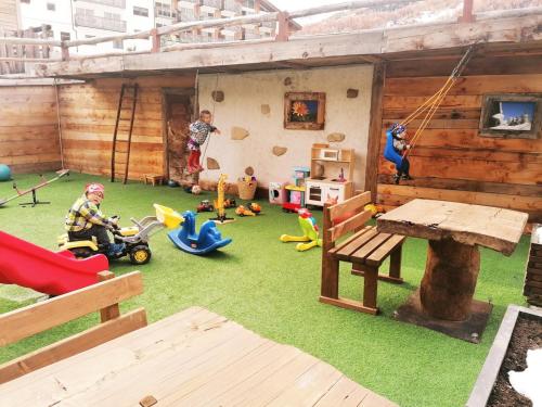 a toy house with a play area with toys at Hotel Le Alpi in Livigno