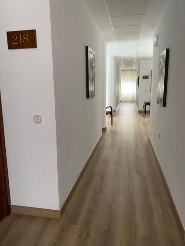 an empty hallway with white walls and wooden floors at Hotel Venta del Pobre in Níjar