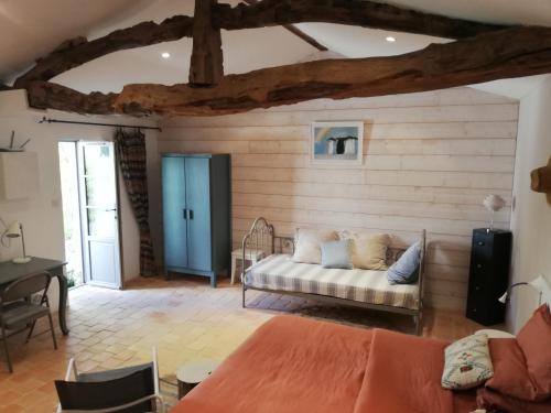 a living room with a couch and a table at Au Logis de la Mongie in Soullans