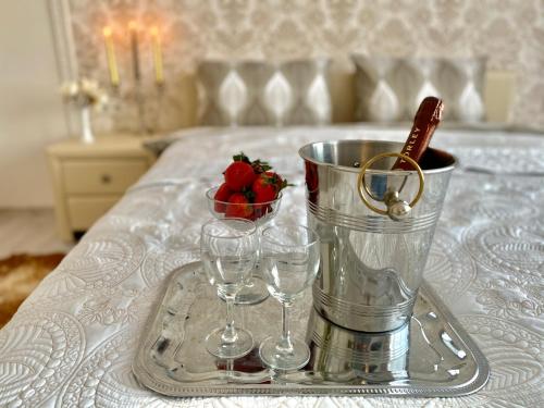 a tray with two wine glasses and a bucket on a bed at Baltic dream Apartments in Sillamäe