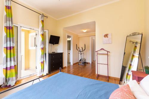 a living room with a bed and a mirror at Spyrelia Villa with Private Pool & Outdoor Hot Tub in Dassia