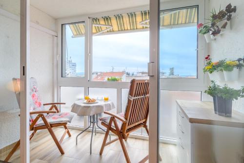 a room with a table and chairs and a window at Apartment Vinka in Split