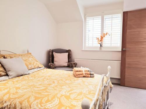 a bedroom with a bed and a dog in a window at 'Little Eaton Margate' Perfectly located Town House by the Sea, with FREE parking! in Kent