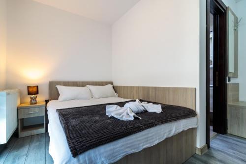 a bedroom with a bed with towels on it at Agropensiunea Andrei & Ianis in Dăeşti