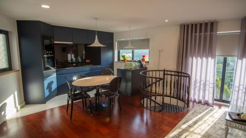 a kitchen and dining room with a table and chairs at dourobluehouse in Marco de Canavezes