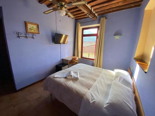 a bedroom with a large bed and a window at Al 182 in Fornaci di Barga