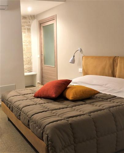 a bedroom with a bed with two pillows on it at LE GRAVINELLE in Ruvo di Puglia