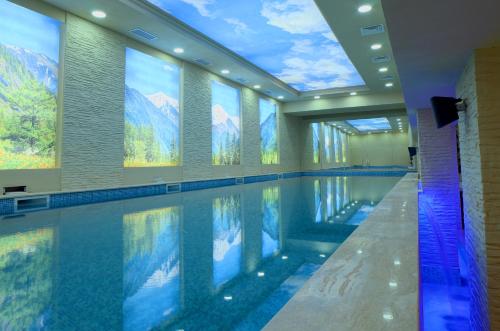 a swimming pool with a view of mountains at Hotel Rila in Dupnitsa