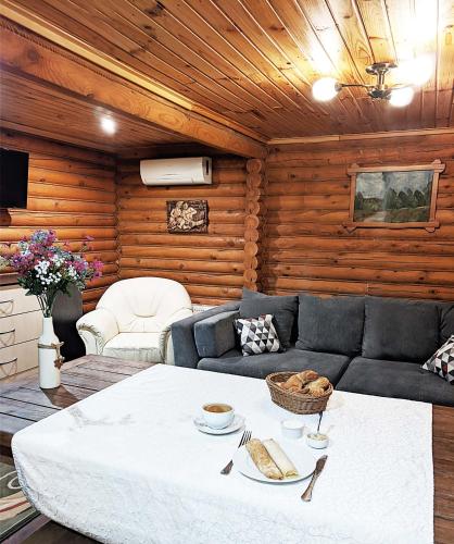a living room with a couch and a table at Котедж-парк Славна in Okhtyrka