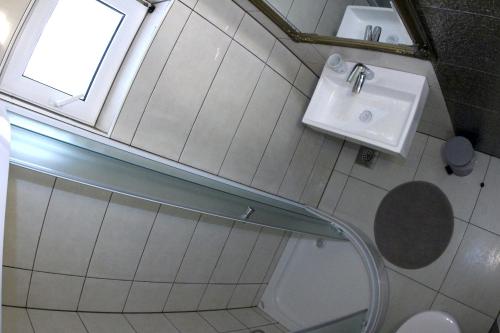 a bathroom with a sink and a toilet and a window at Apartments Giardino in Hvar