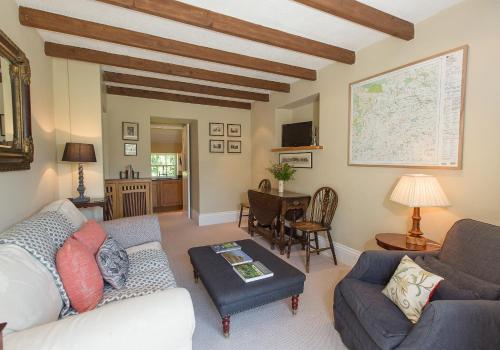 a living room with a couch and a table at Shieldhall - Cabinetmakers Suite in Morpeth